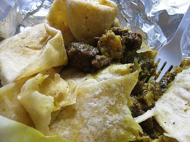 Curry goat and potatoes with paratha roti