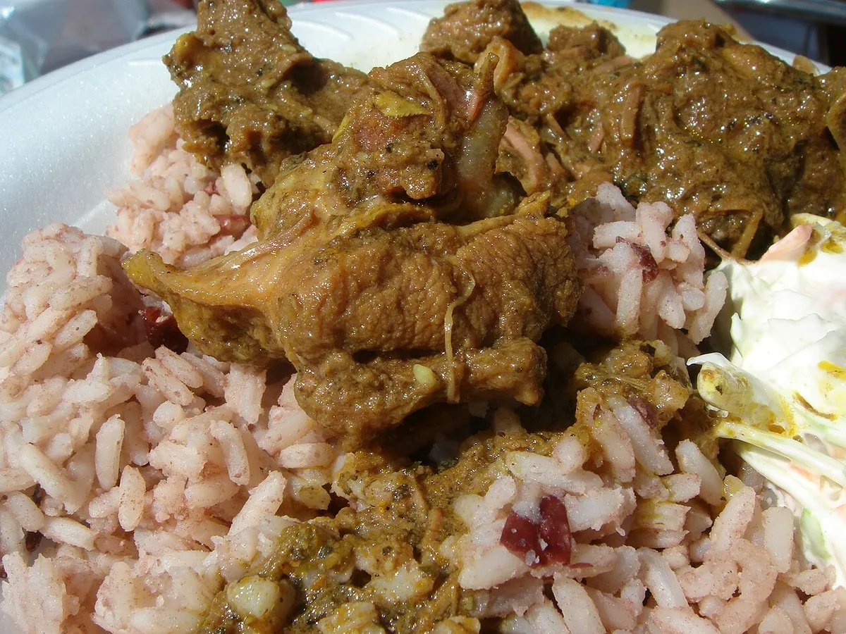 Curry goat with rice and peas in a lunch box, Jamaica