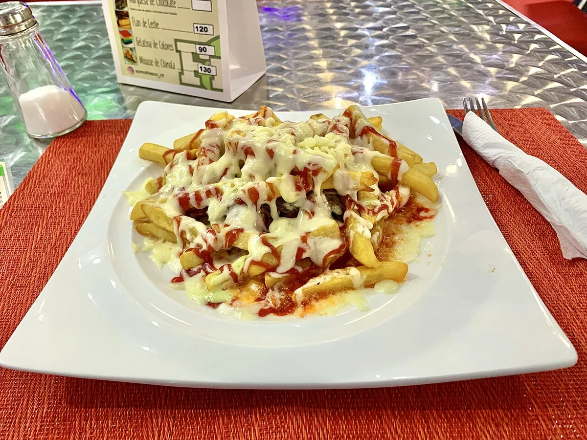 Yaroa: fries layered with meat, cheese, and sauces, Dominican Republic
