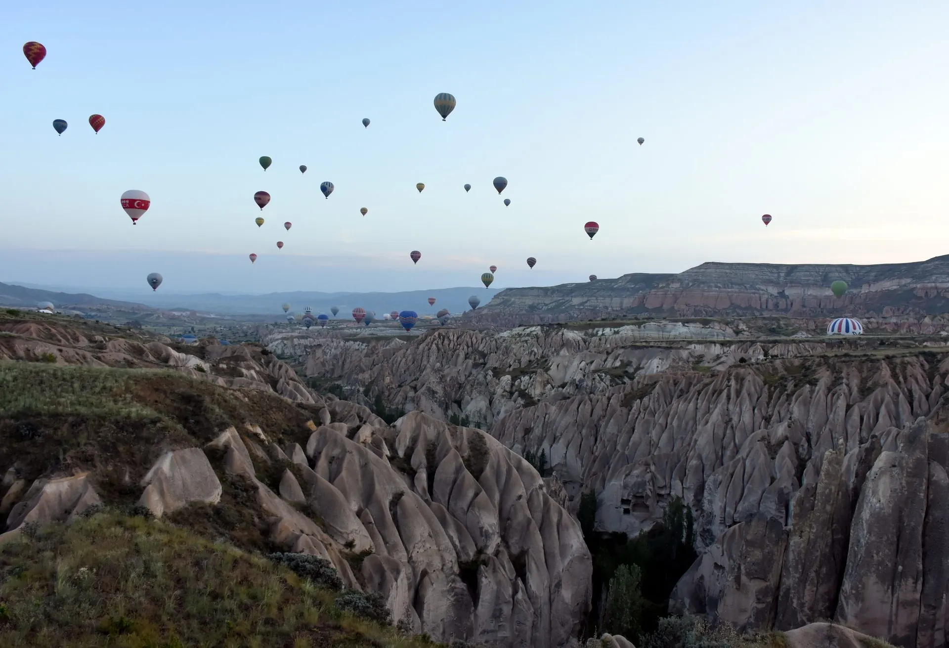 Hot air balloons over the valleys near Goreme, Cappadocia, at dawn