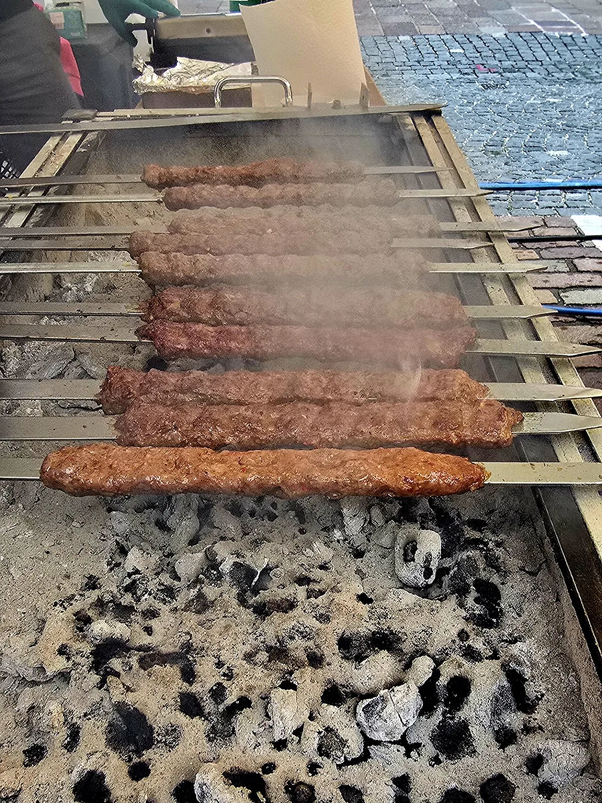 Kefta skewers over charcoal at a street grill