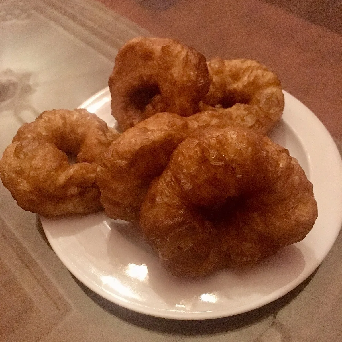 Sfenj, fried dough rings, on a breakfast plate