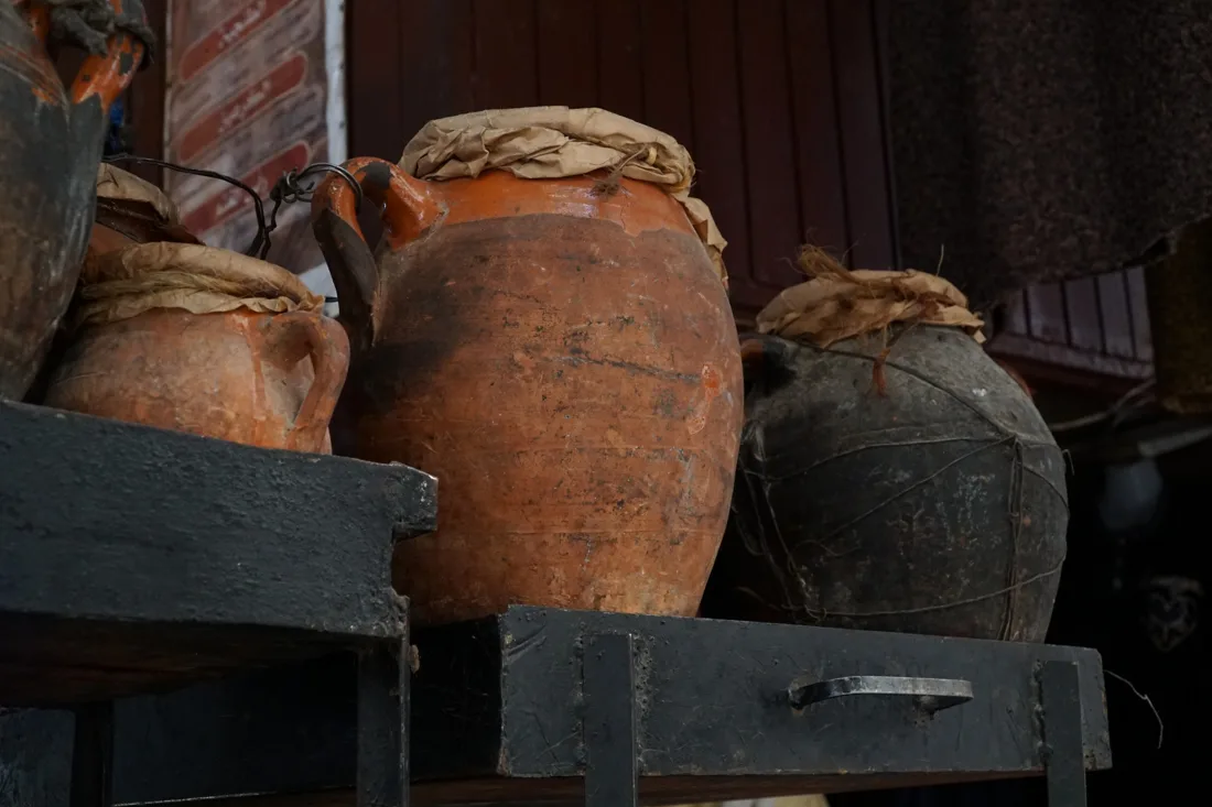 Sealed tanjia urns in a Marrakech souk, waiting for the hammam ashes
