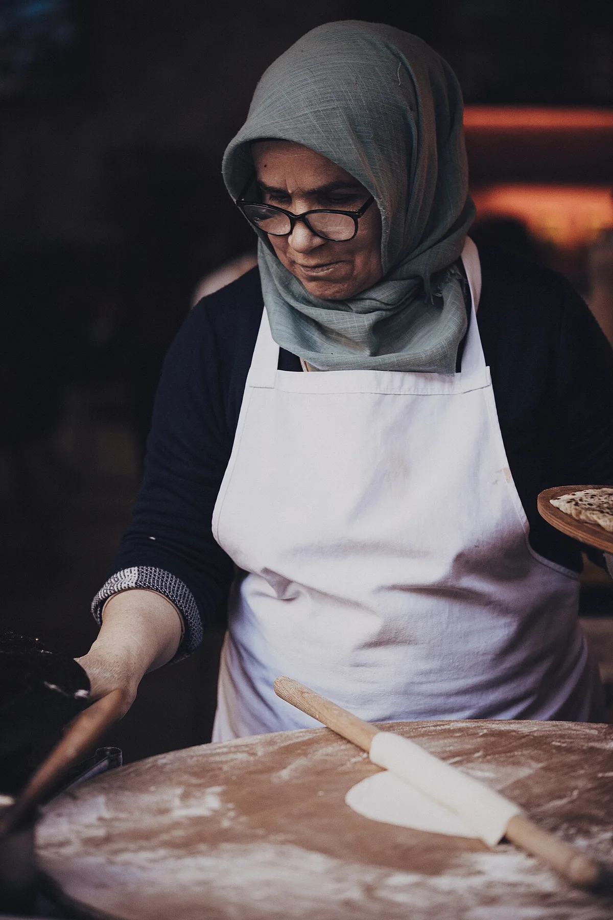 Rolling gözleme dough to order at a market stand