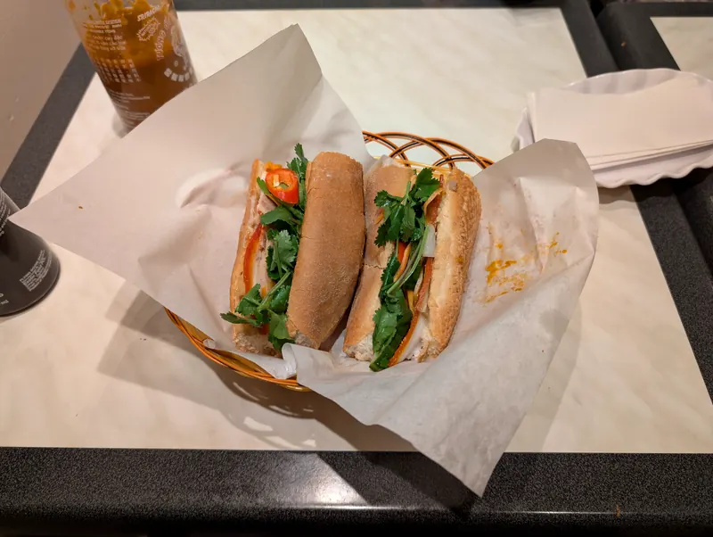A banh mi dac biet (special combo): pork belly, pork roll and pate in a crackling baguette, Saigon