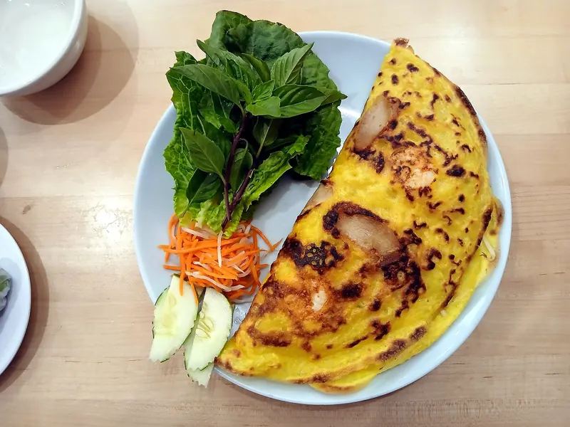 Banh xeo, the sizzling turmeric crepe, with herbs