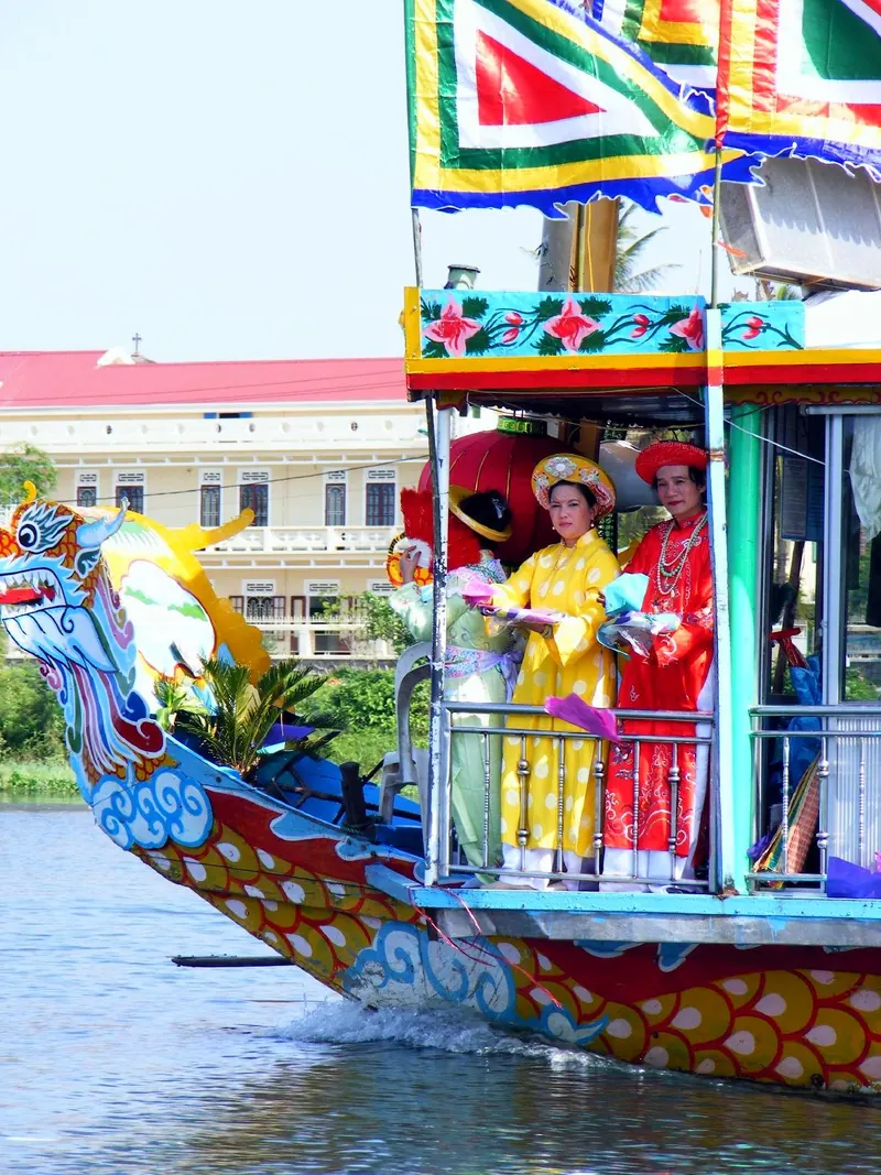 Performers on a dragon boat on the Perfume River during Hue Festival