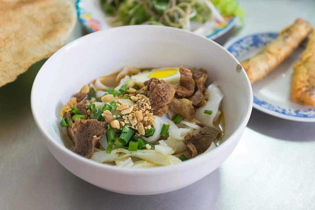 Mi Quang in Da Nang: turmeric noodles, beef, quail egg, and peanut