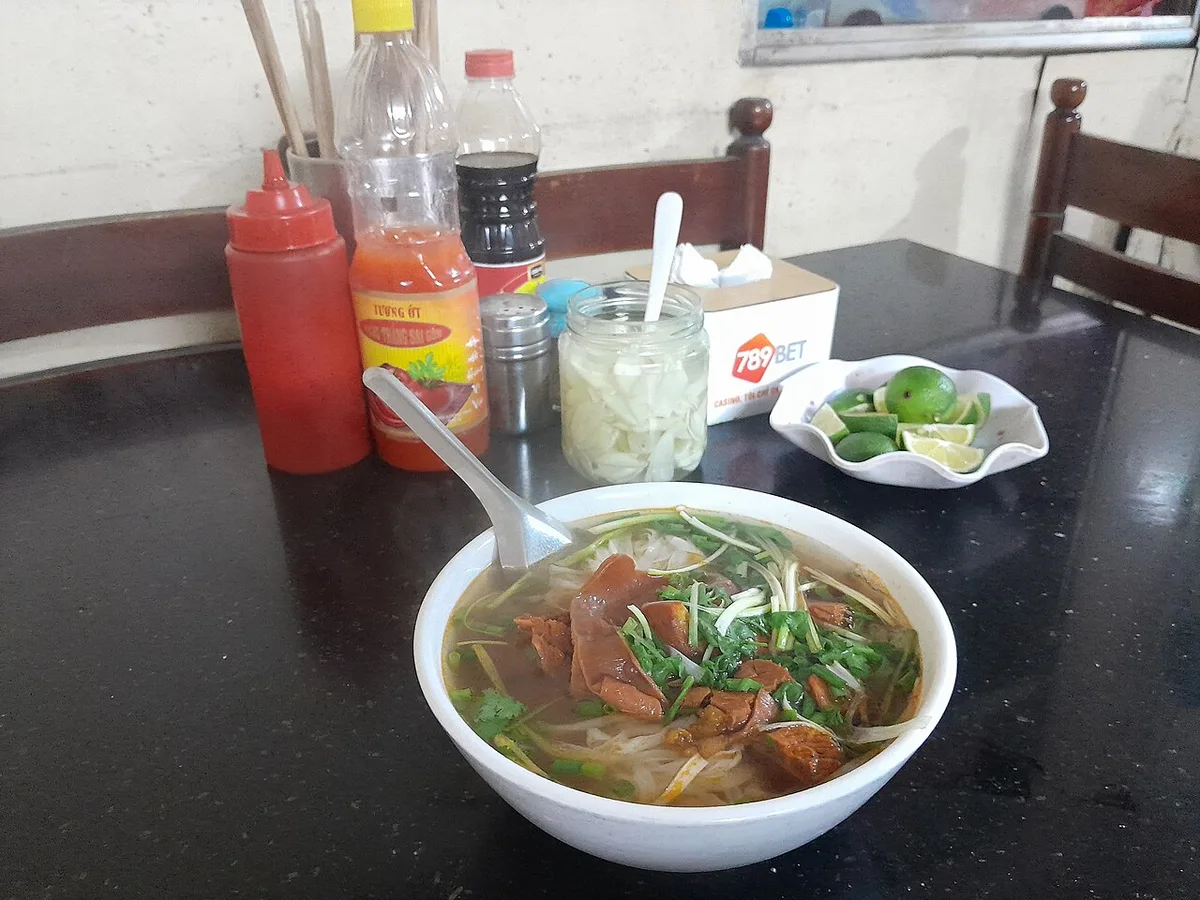 A bowl of pho on the table at a Hanoi noodle stall