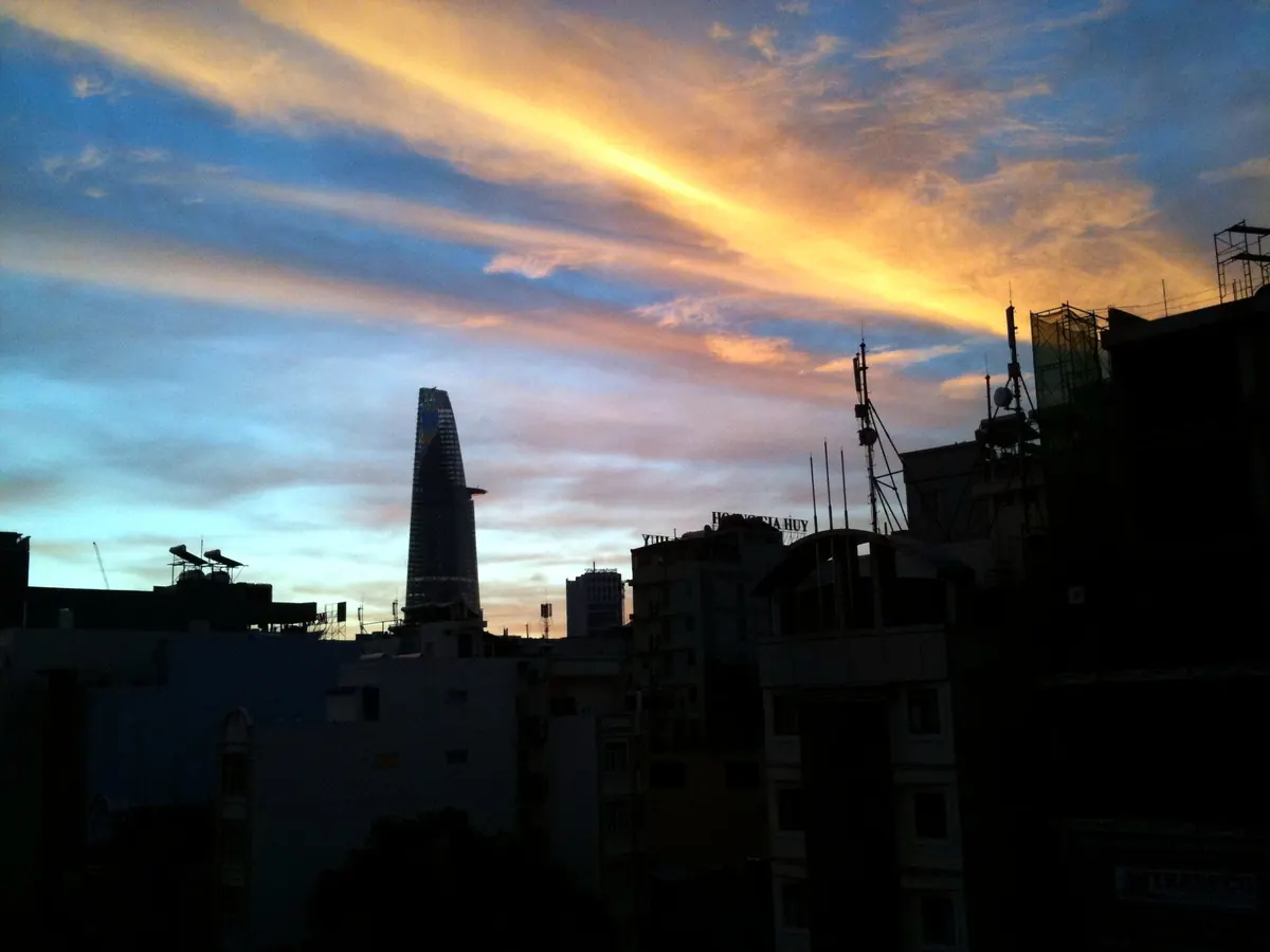 The Ho Chi Minh City skyline at sunrise, with the Bitexco Financial Tower